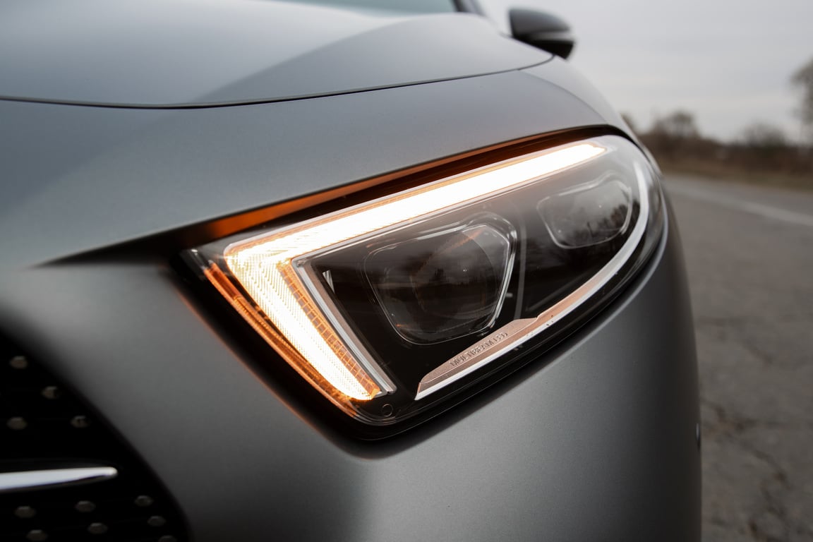 Shiny headlight of modern new gray car